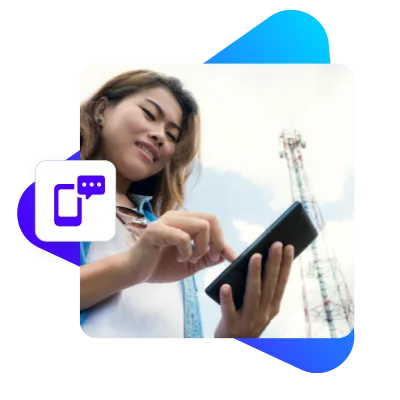 Image of a telecommunications working looking at a mobile device in front of a cell tower